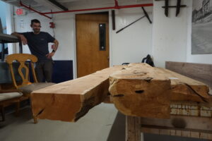 Employee looking at pieces of rough lumber