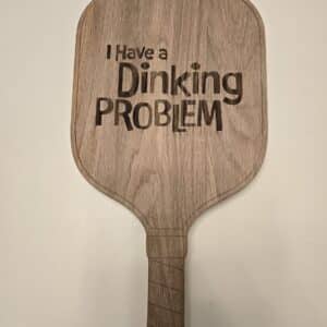 Serve up a win at your next gathering with the ultimate accessory for the pickleball obsession. Shaped exactly like a regulation paddle, this handcrafted charcuterie board moves seamlessly from the court conversation to the kitchen counter.